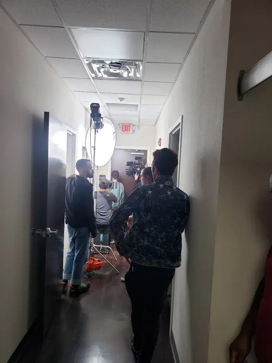 A light and crew in an office hallway